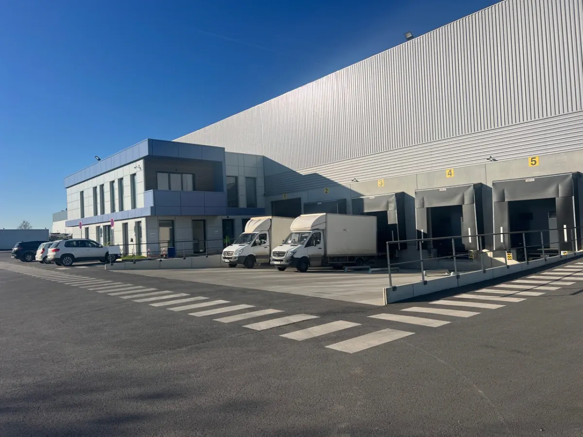 FEESGO warehouse exterior with loading docks and delivery vehicles